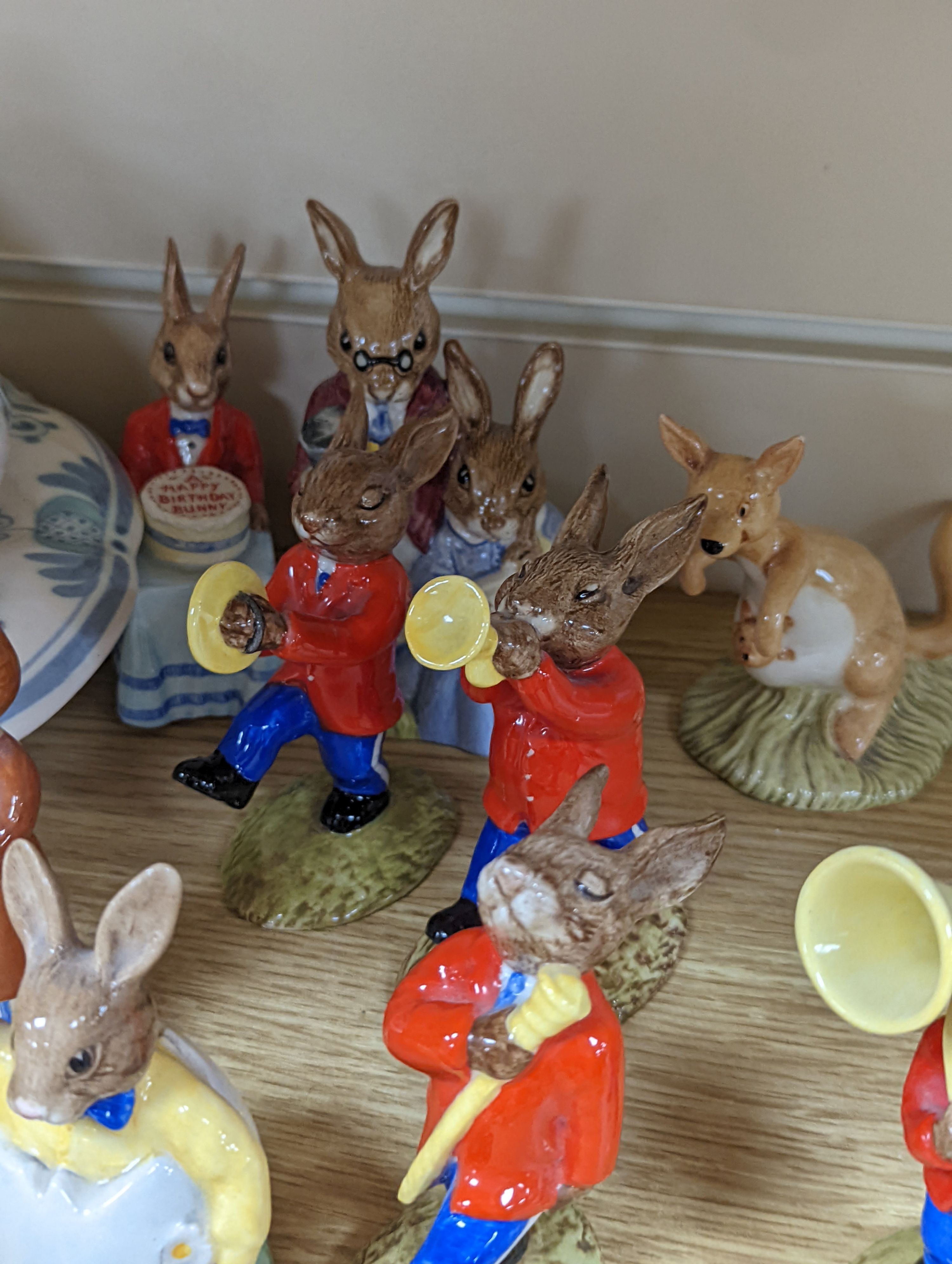 A collection of Royal Doulton figures including Bunnykins, a Doulton vase and other items